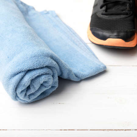 running shoes and towel on white wood tableの写真素材