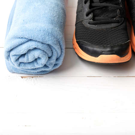 running shoes and towel on white wood tableの写真素材