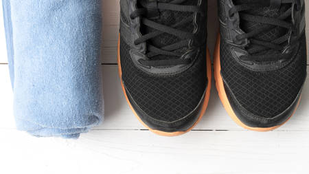 running shoes and towel on white wood tableの写真素材