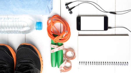fitness equipment : running shoes,towel,jumping rope,water bottle,phone,notepad and measuring tape...