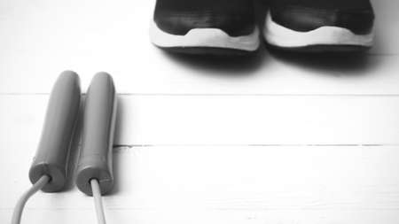 running shoes and jumping rope on white table black and white tone color styleの写真素材