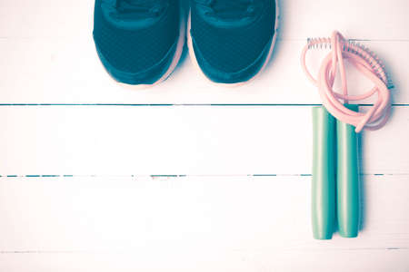 running shoes and jumping rope on white table vintage styleの写真素材