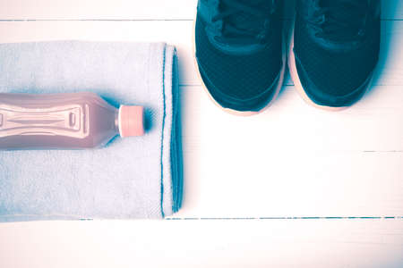 running shoes,towel and orange juice on white wood table vintage styleの写真素材