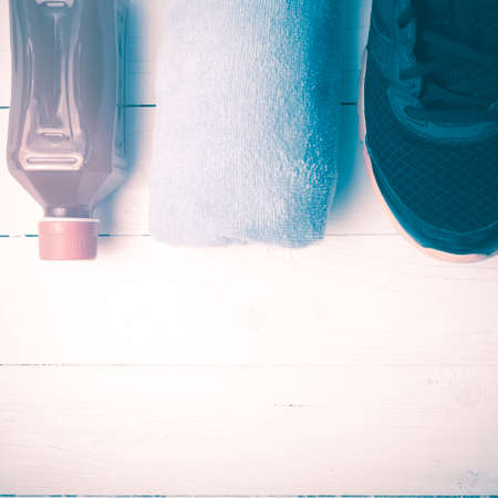 running shoes,towel and orange juice on white wood table vintage styleの写真素材