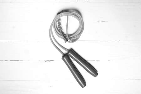 jumping rope on white wood table black and white color style