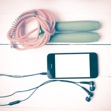 fitness equipment : jumping rope and phone on white wood table vintage styleの写真素材