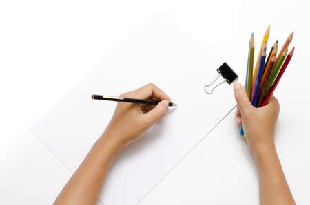 asia woman right hand with black pencil and left hand with colorful pencil on blank white paper over white backgroundの写真素材