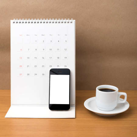 coffee cup and phone and calendar on wood background