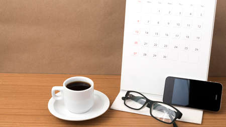 coffee,phone,eyeglasses and calendar on wood table background