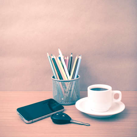coffee,phone,car key and heart on wood table background vintage styleの写真素材