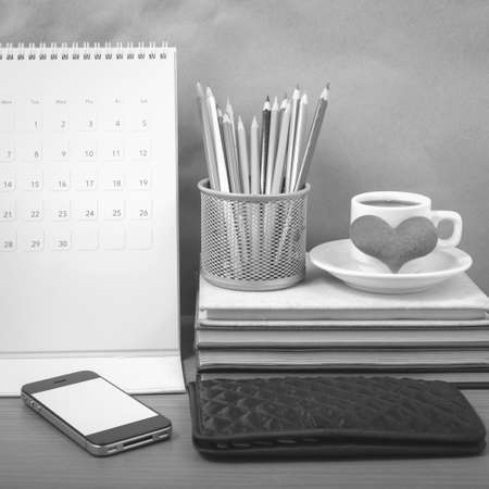 office desk : coffee with phone,wallet,calendar,heart,color pencil box,stack of book,heart on wood...