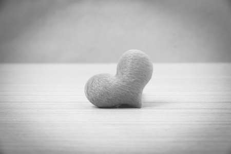 red heart on wood table background black and white colorの写真素材