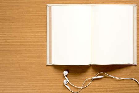 top view of notebook and earphone on wood backgroundの写真素材