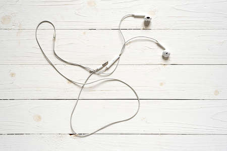 top view of earphone on white wood backgroundの写真素材