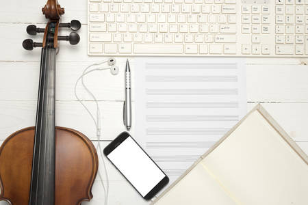 violin with keyboard computer music paper note notebook and smart phone on white wood backgroundの写真素材