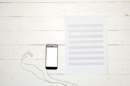 smart phone with music paper note on white wood backgroundの写真素材
