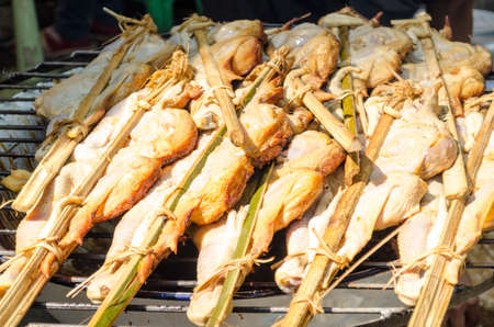 Grilling spiced chicken, roasted chicken at street food vendor market, Thai style food.の写真素材