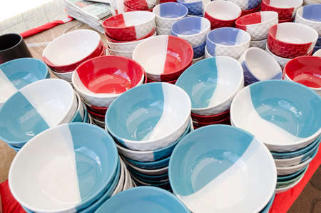 Stacked ceramic bowls and mugs ceramic products for saleの写真素材