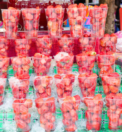 selling strawberry in plastic cup at Jatujak weekend market,Bangkok Thailand.の写真素材