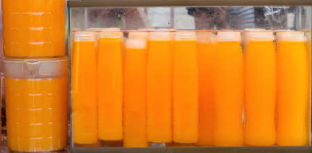 selling orange juice at Jatujak weekend market Bangkok Thailand.