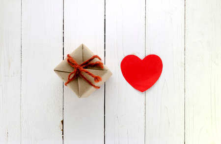 top view of craft gift box and heart concept vanlentine on white wood backgroundの写真素材