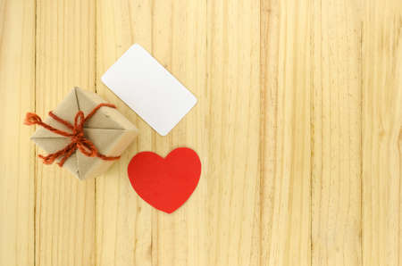 top view of craft gift box with heart on wood background concept lovetop view of craft gift box with heart on wood background concept loveの写真素材