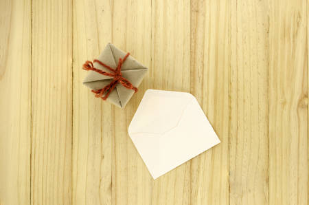 top view of craft gift box with envelope on wood backgroundの写真素材