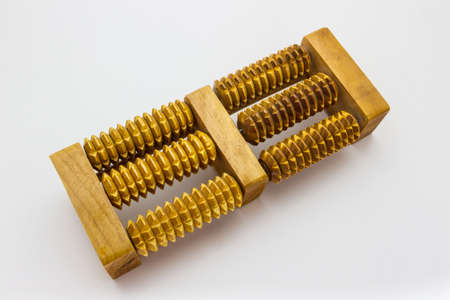 Wooden foot massage on the white background の写真素材