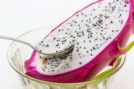 Spoon in the rind of a dragon fruitの写真素材