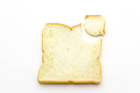 Close-up image of slice of white bread against the white background