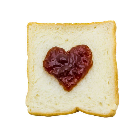slice of bread with red jam heart on isolated white background の写真素材