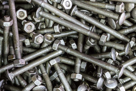 Close up of a bunch of metal nuts and bolts. の写真素材