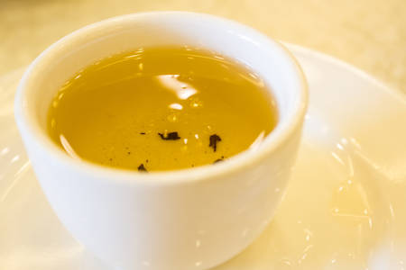 Chinese tea in a white cup on the table.