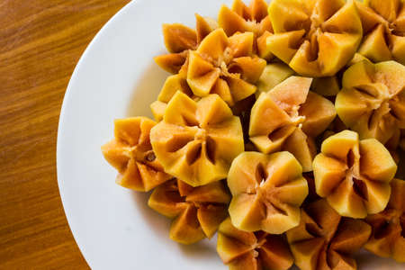 Fresh Sapodilla fruit carving on the plate. Thai carving fruit.の写真素材