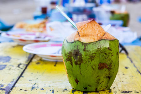 Coconut water drink on table at beach.の写真素材