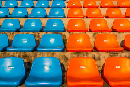 The empty blue and orange stadium seat for watch some sport or football.のeditorial素材