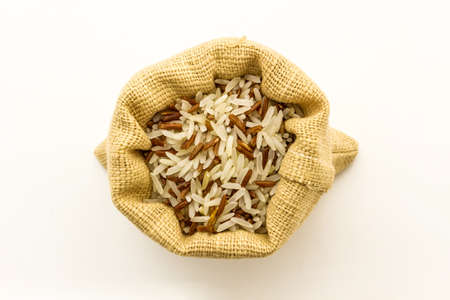Brown rice mixed white (jasmine) rice in small burlap sack isolated on white. 
の写真素材
