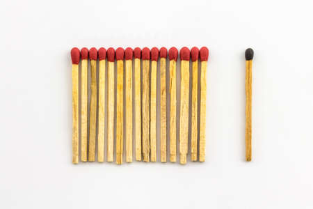A series of  red matches are next to each other, which different black one  の写真素材