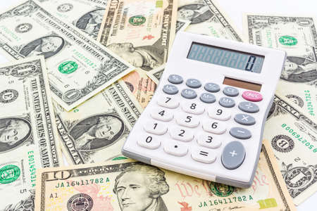 Digital calculator on a heap of paper dollars.の写真素材