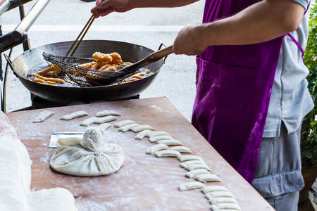 Threshing and cutting flour in process deep fried dough の写真素材
