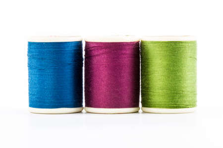Three spools of sewing thread isolated on white 