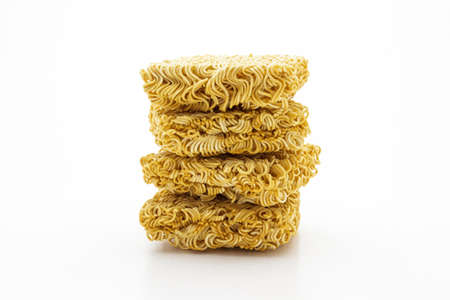 Stack of raw instant noodle on white background の写真素材