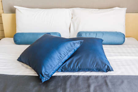 Pillow on double bed in a business home and hotel bedroom.の写真素材
