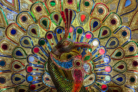 Beautiful of colorful jewel peacock. Mosaic handicraft made from small colorful of glass ,Thailand.の写真素材
