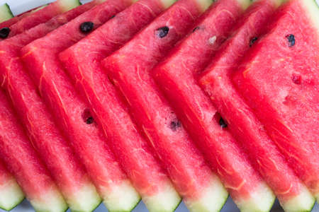 Fresh slices of ripe  sweet watermelon on white plate.