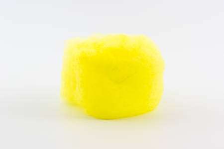 Closeup yellow spun sugar on white background, Cotton Candy.の写真素材