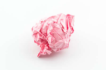 Crumpled pink papers into a ball on white background. 