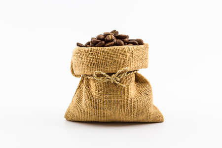 Brown roasted coffee beans  in a canvas sack on white background.の写真素材