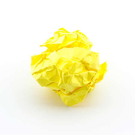 Crumpled yellow papers into a ball on white background.の写真素材