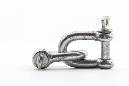 Steel hardware for fitting electrical cable on white background. の写真素材